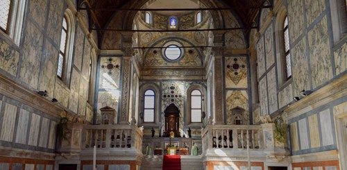 Interior of the Church of Santa Maria dei Miracoli in Venice, with its marble-clad walls and altar.