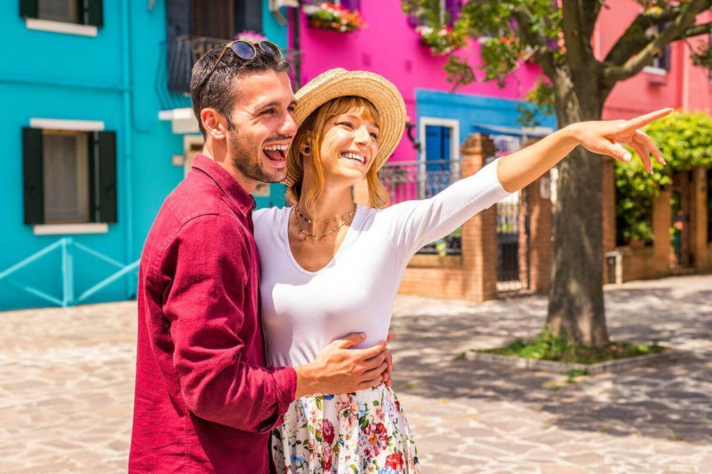Happy couple among colorful houses in Burano.
