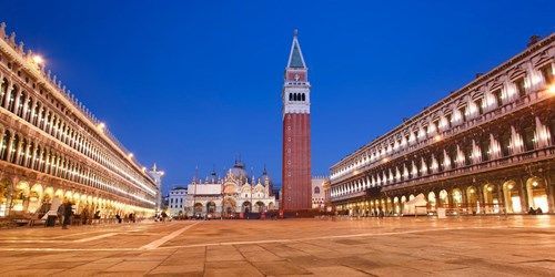 St. Mark's Square and the Campanile illuminated at twilight.