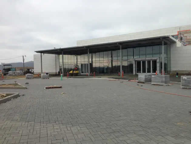 Claddagh Paving Corporation -  large building with a lot of windows is being built on a cloudy day.