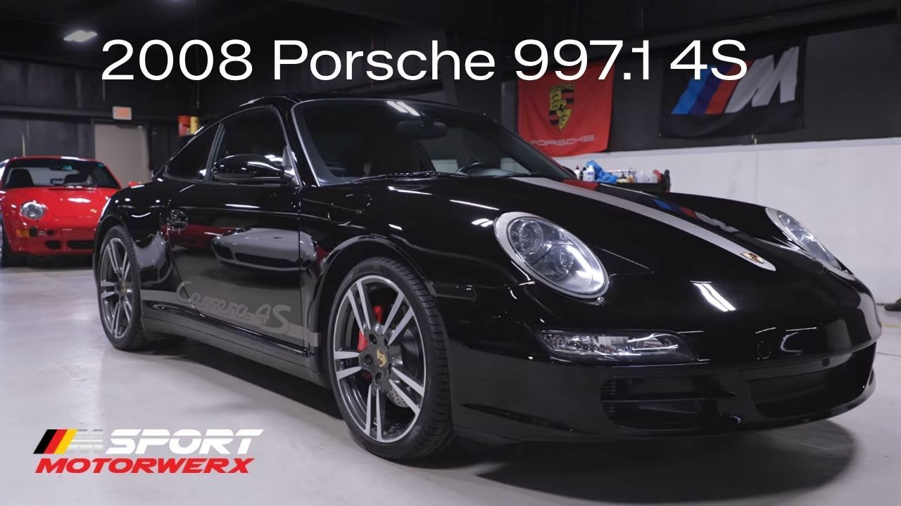 Black 2008 Porsche 997.1 4S in showroom, front three-quarter view with Sport Motorwerx logo