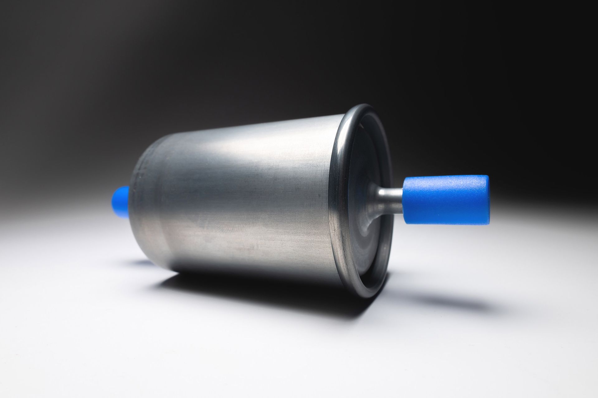 Fuel filter, silver metal cylinder with blue plastic ends.