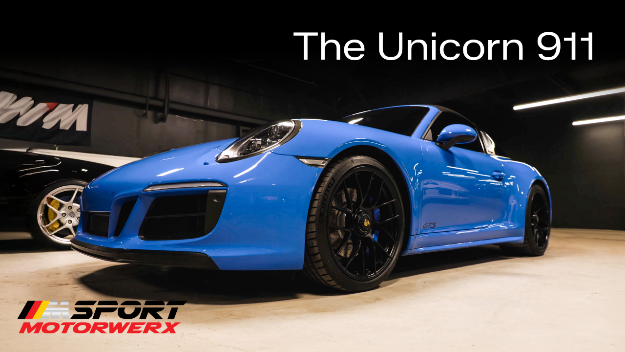 Blue Porsche 911 sports car in a showroom with “The Unicorn 911” title text above
