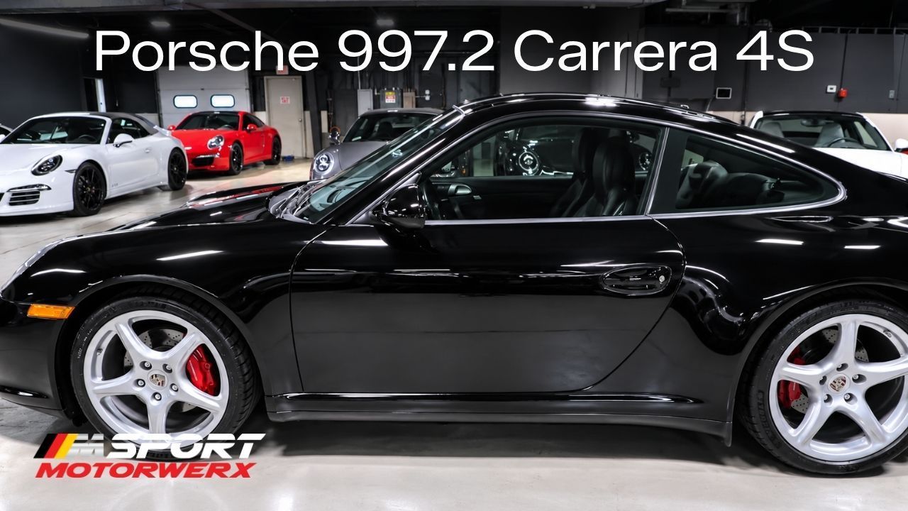 Black Porsche 997.2 Carrera 4S coupe in a showroom, side view with silver wheels