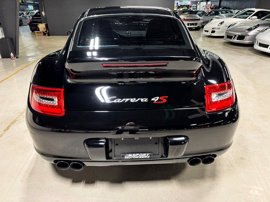 Rear view of a black Chrysler Crossfire SRT in a parking garage