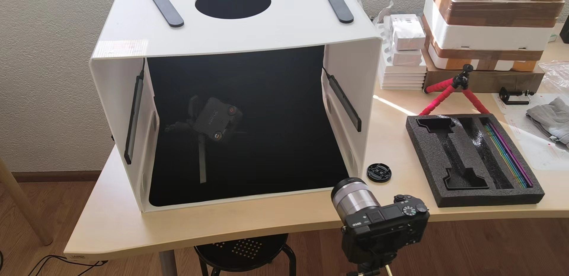 A camera is sitting inside of a box on a table.