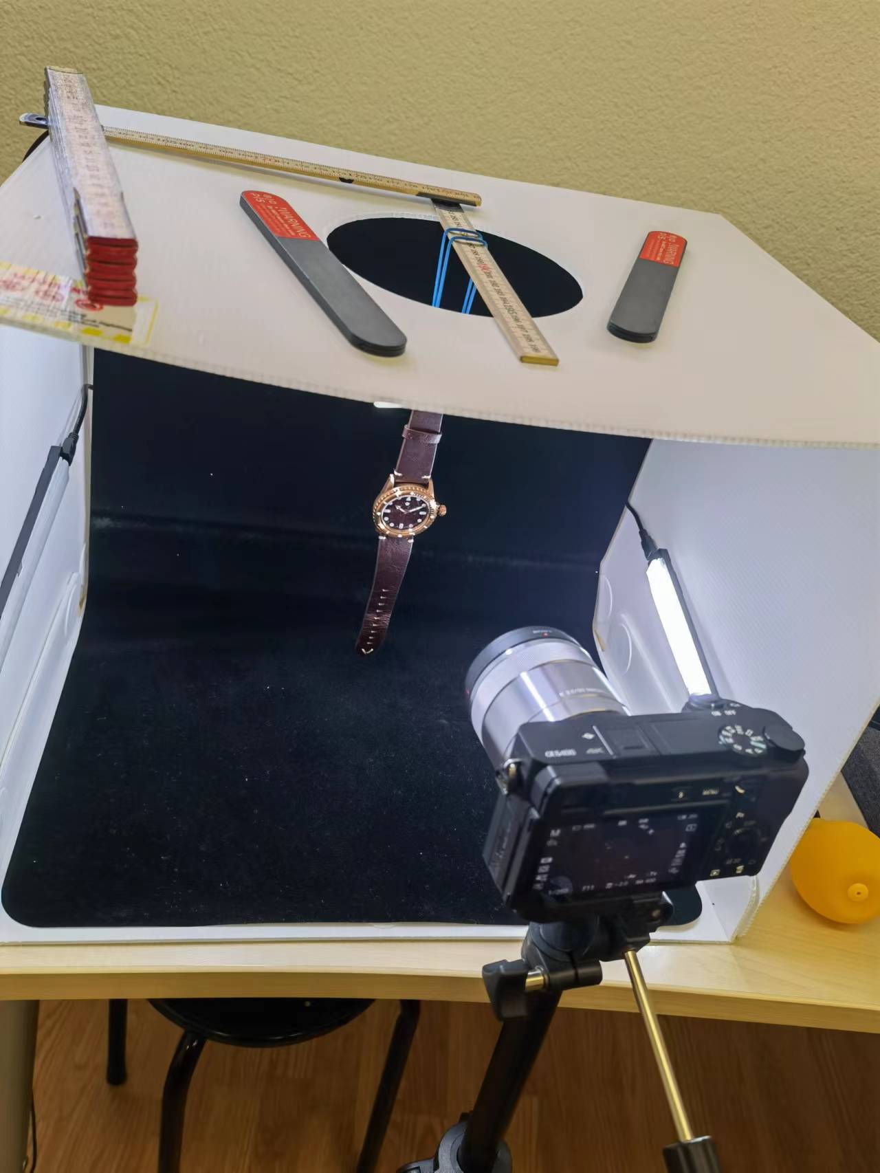 A camera is taking a picture of a watch in a box