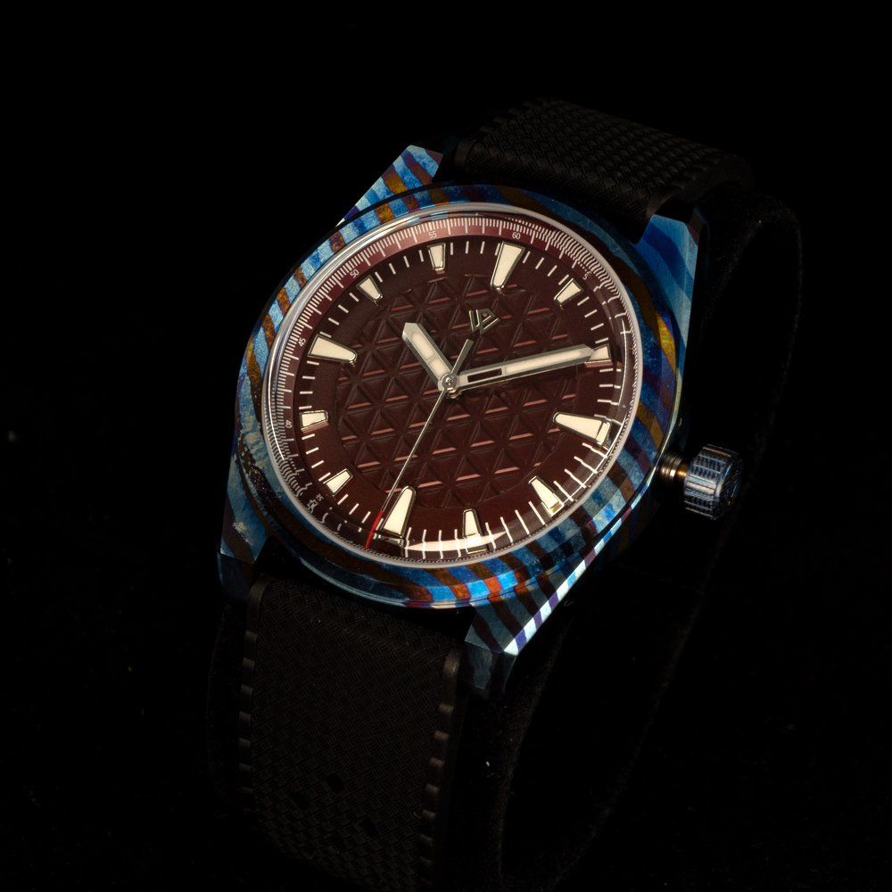 A close up of a watch on a black background.