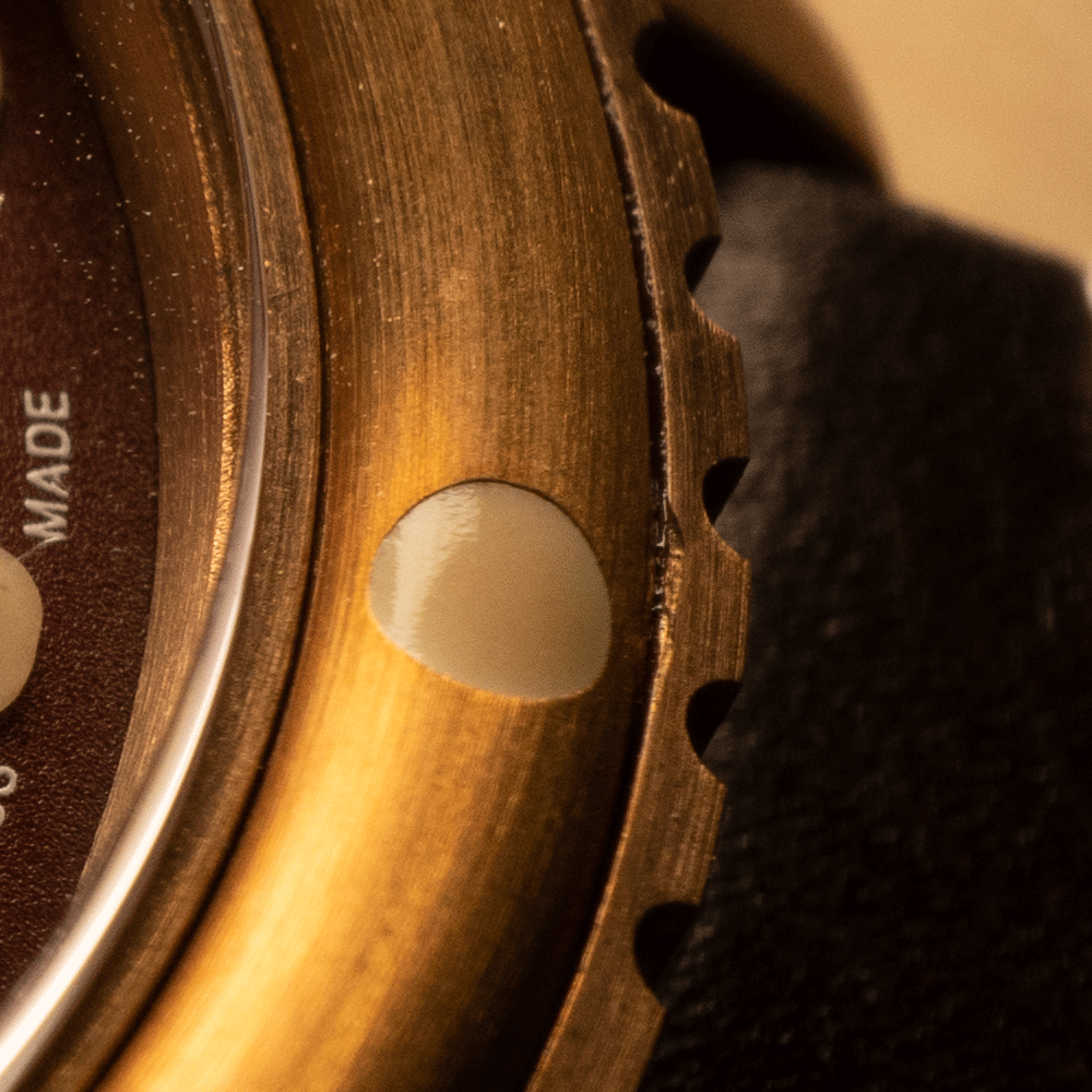 A close up of a watch with the word made on it
