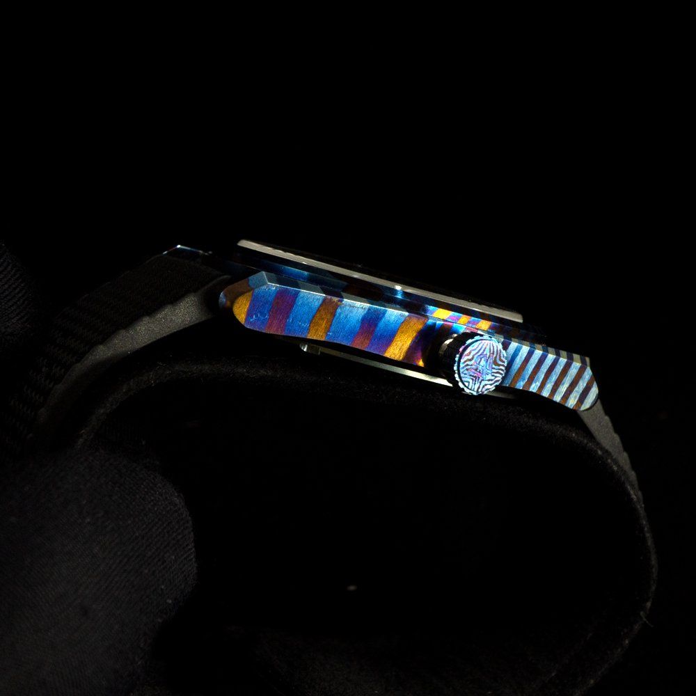A close up of a watch on a black background
