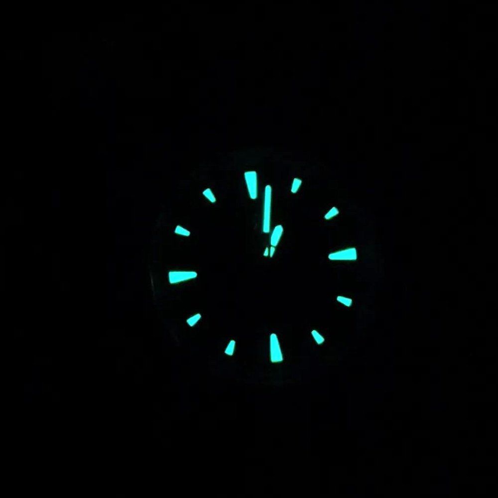 A close up of a glow in the dark clock face