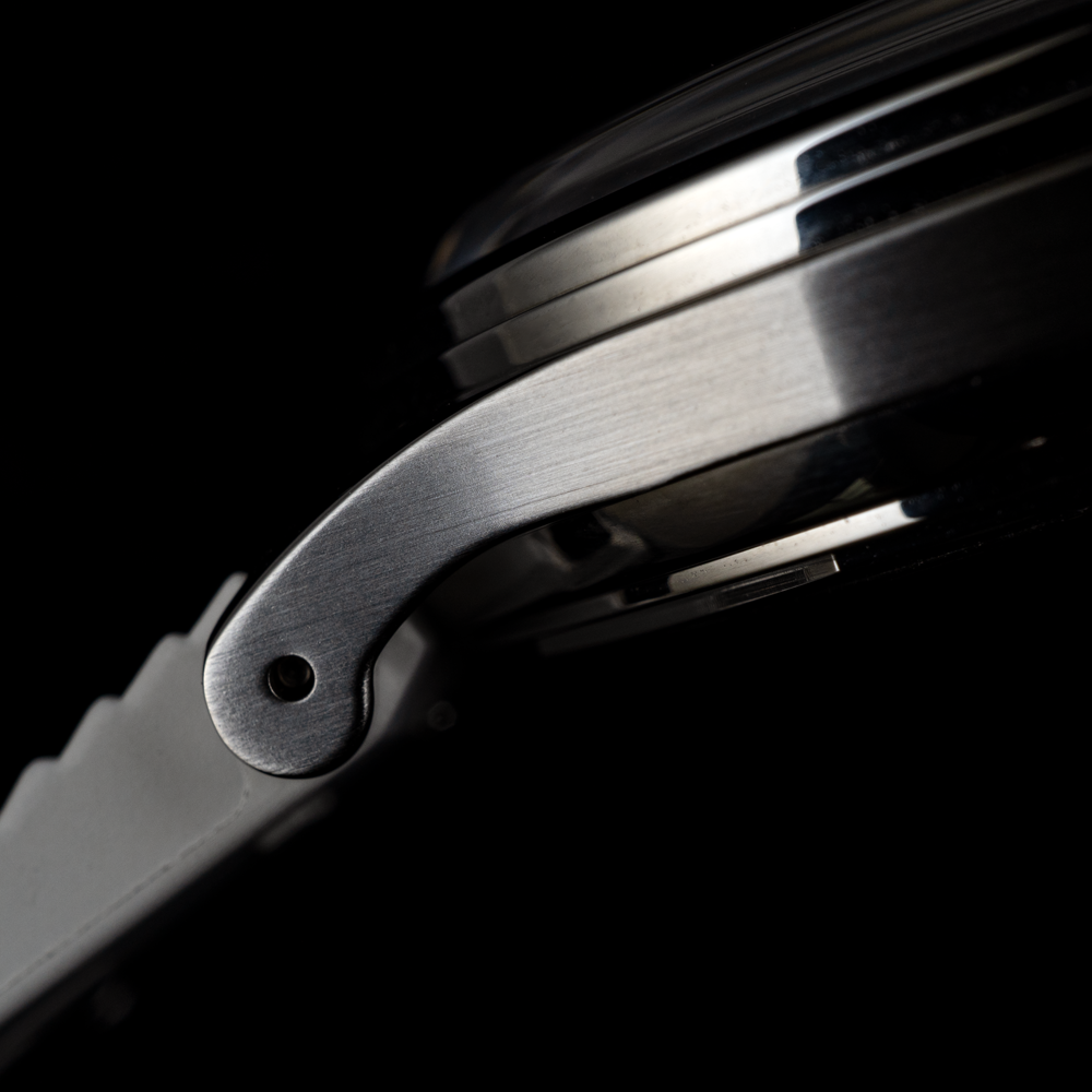 A close up of a watch face with a black background