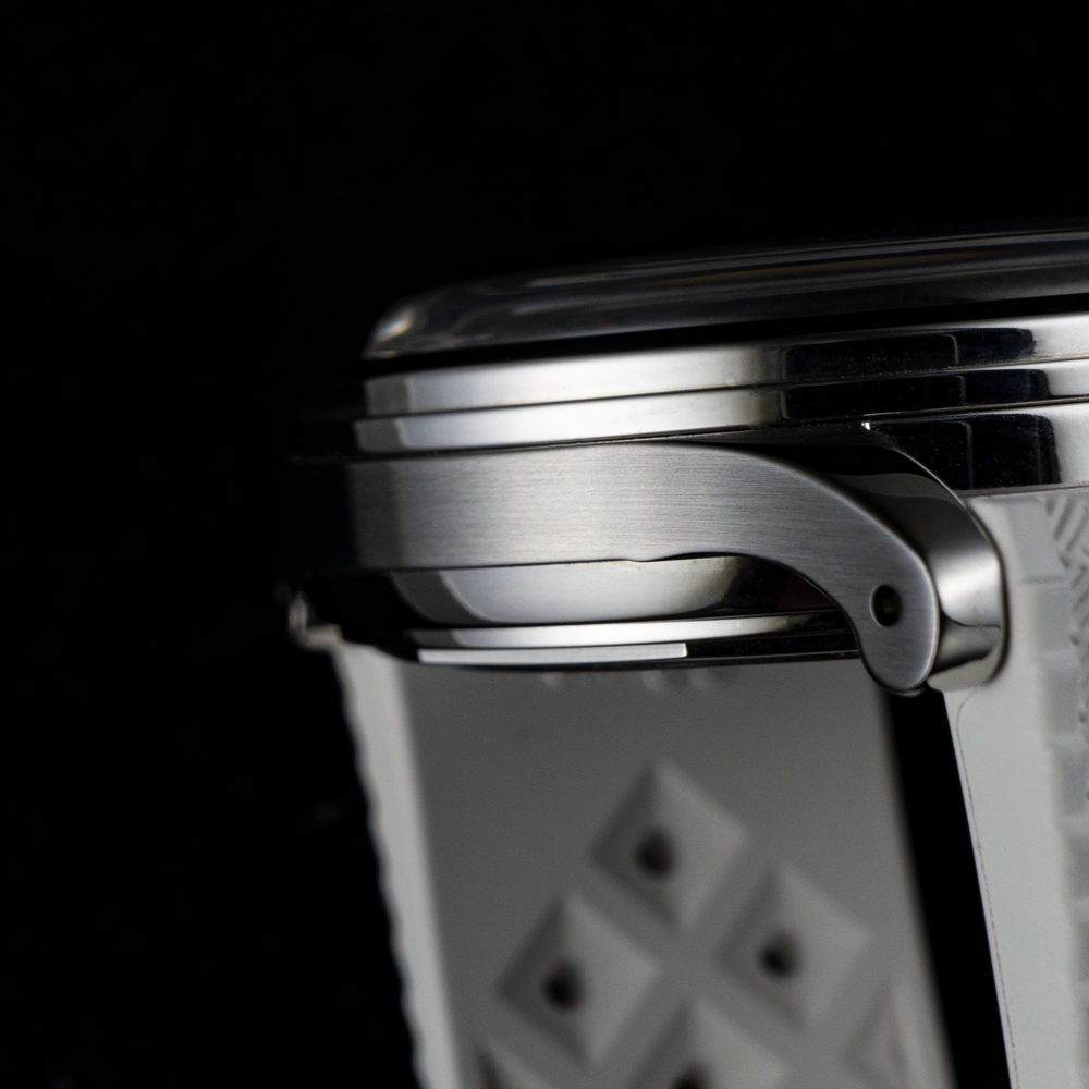 A close up of a watch face on a black background