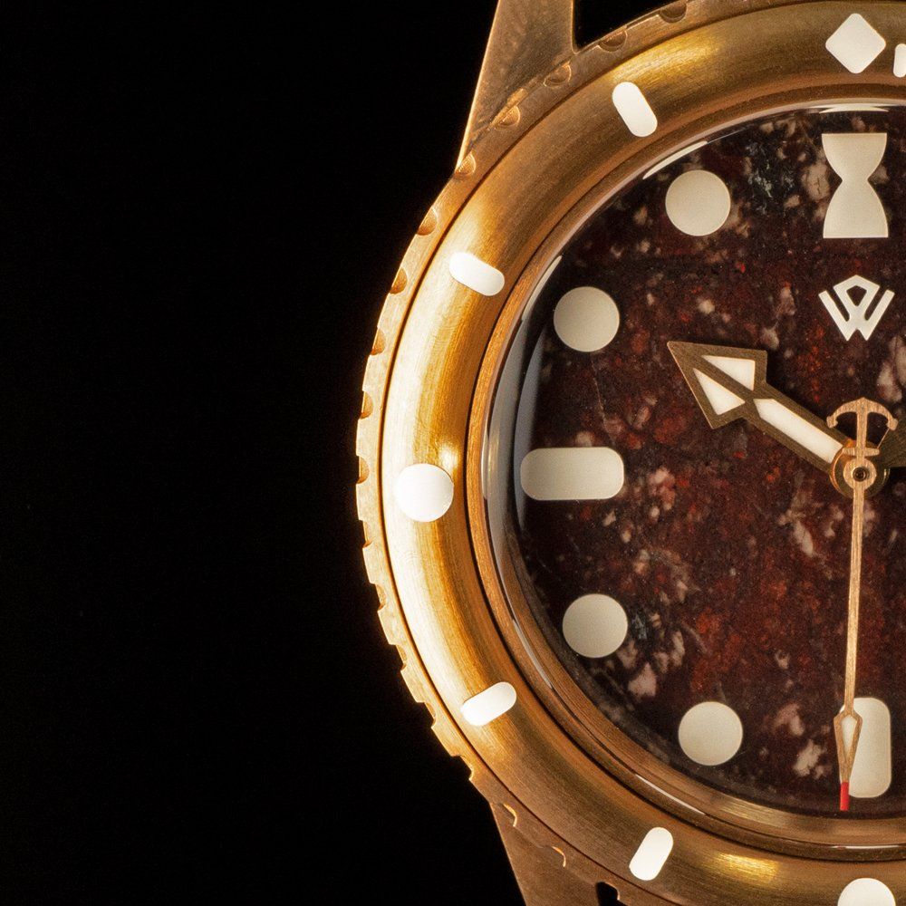 A close up of a watch face that shows the time as 4:20