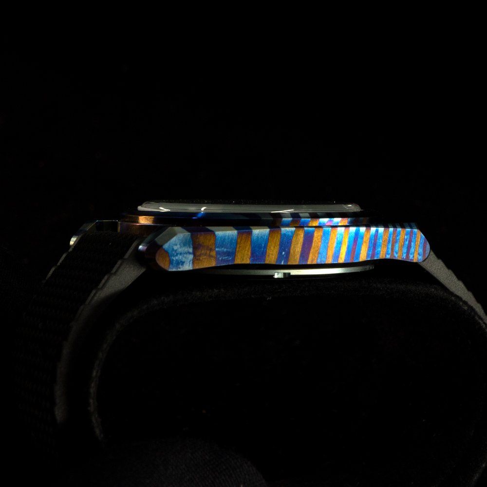 A close up of a watch on a black background