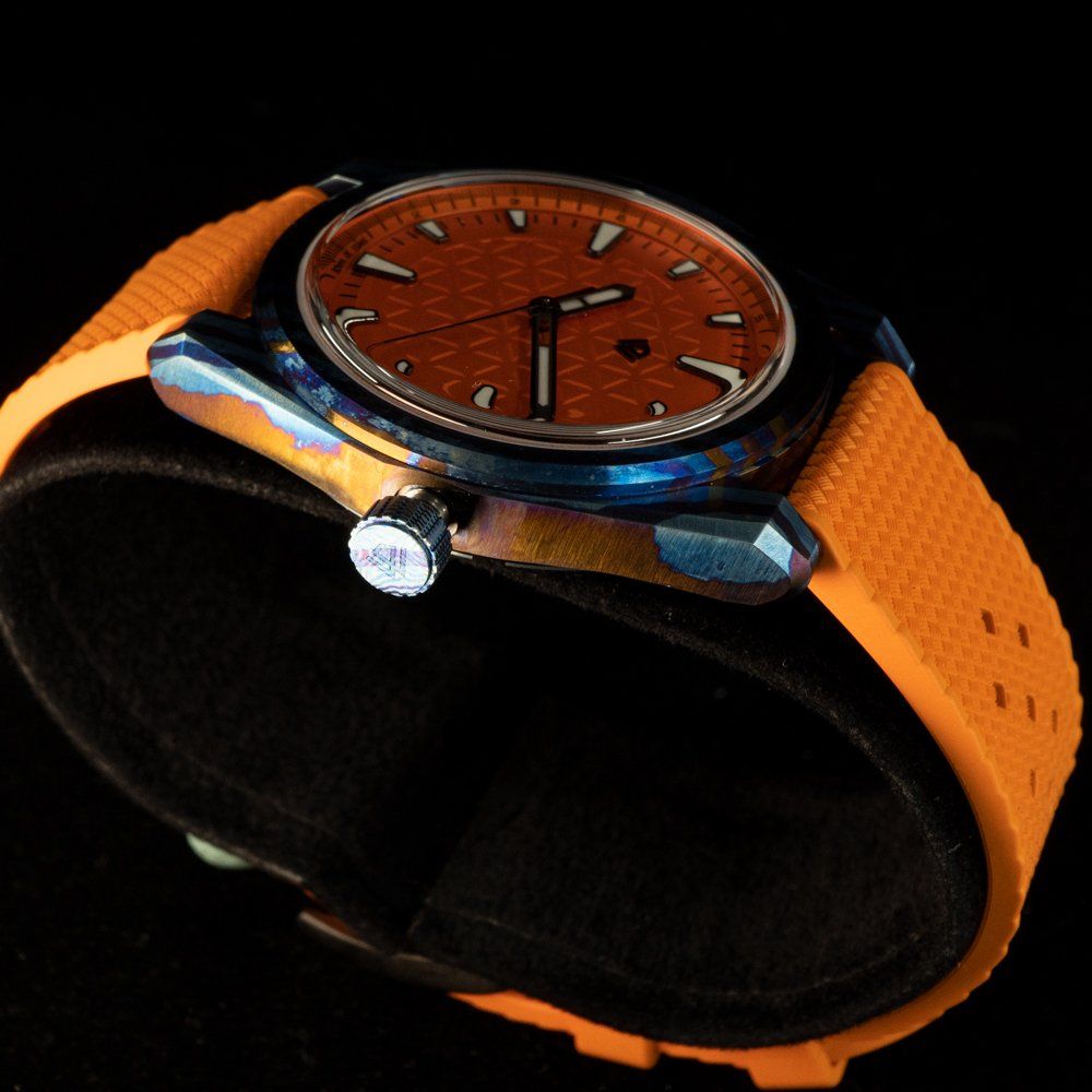 A close up of a watch with an orange band