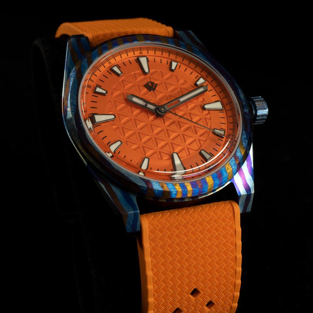 A close up of an orange watch on a black background