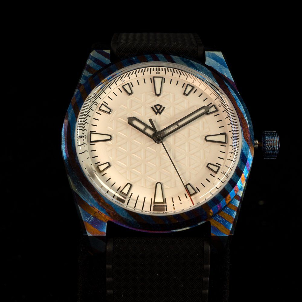 A watch with a black band and a white face