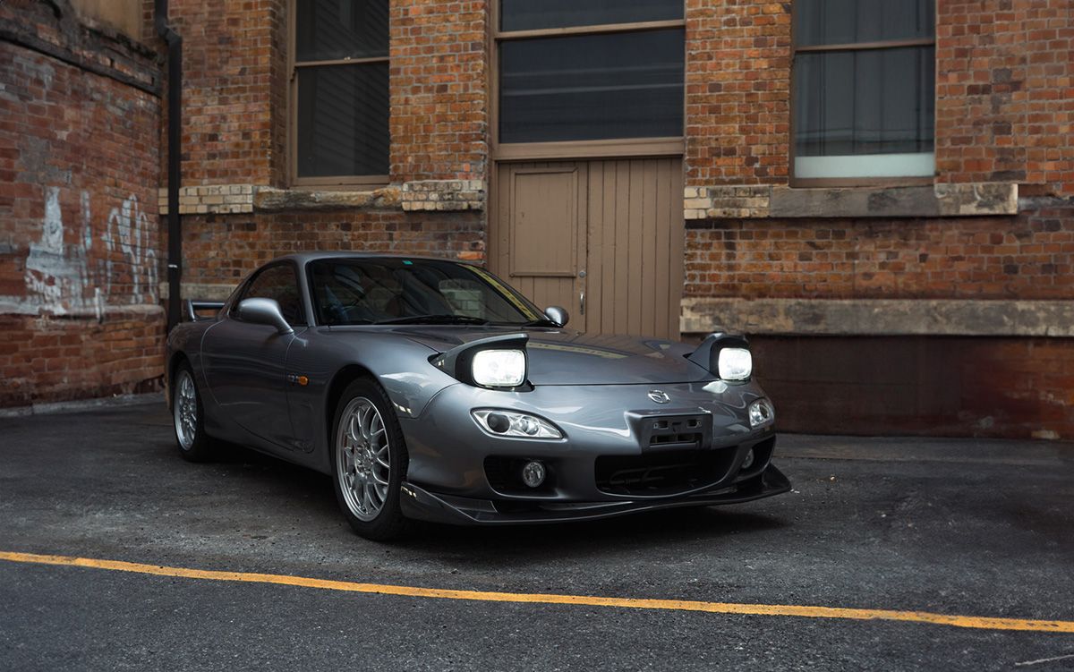 An Unregistered Mazda RX-7 Parked in Front of A Brick Building | Sell Any Car Fast Brisbane, QLD