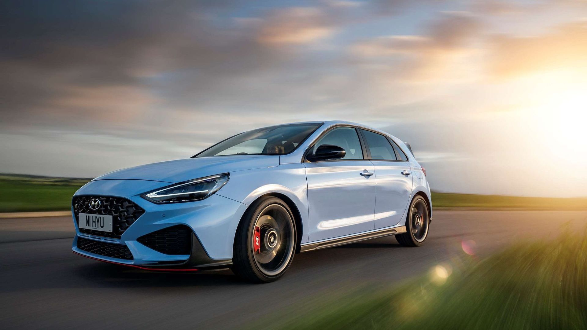 A Blue Hyundai i30Car Is Driving Down a Road at Sunset — Sell Any Car Fast in Eagle Farm, QLD