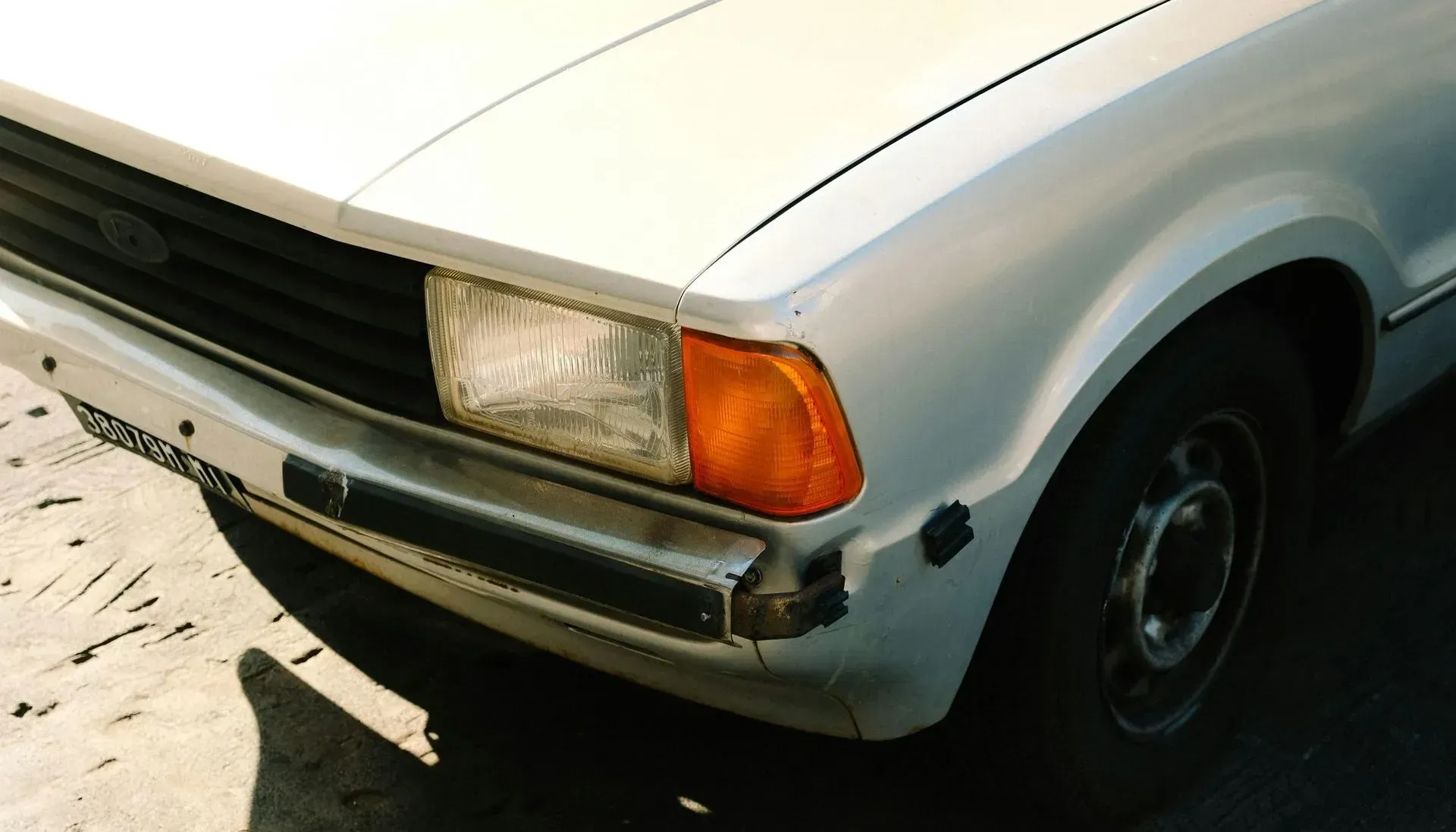 A White Ford Car Is Parked on The Side of The Road — Sell Any Car Fast in Eagle Farm, QLD