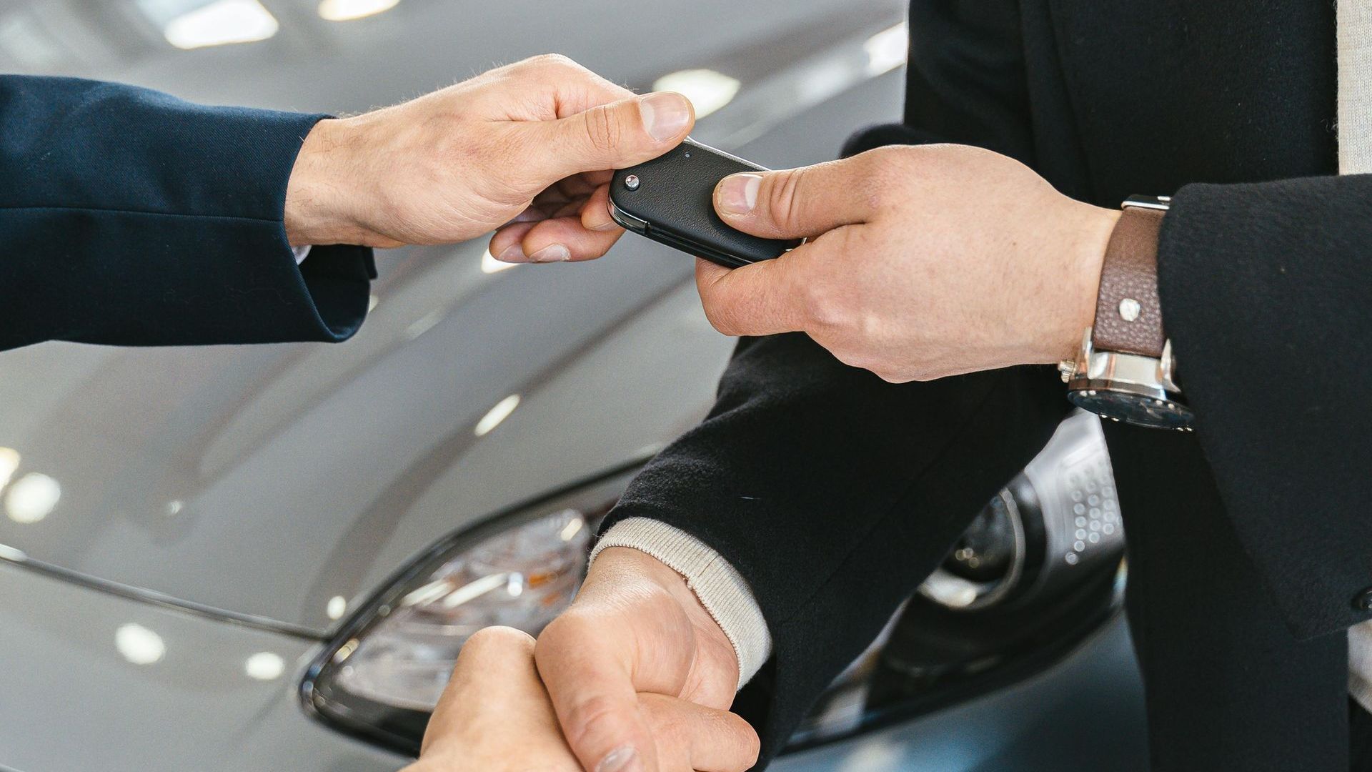 A Man Is Handing a Car Key — Sell Any Car Fast in Eagle Farm, QLD