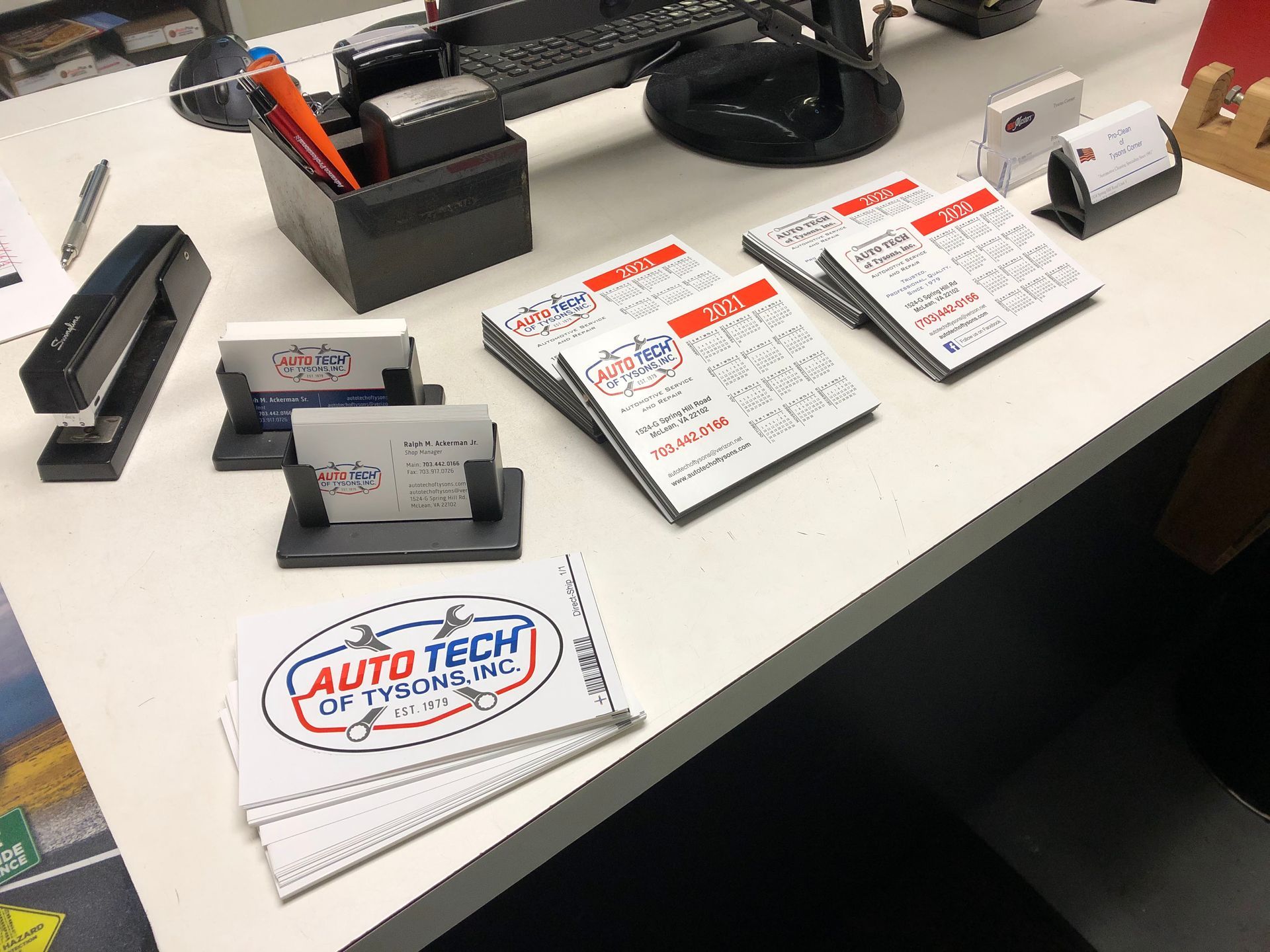 Business cards for Auto Tech of Michigan are arranged on a desk with a stapler and desk organizer | Auto Tech of Tysons