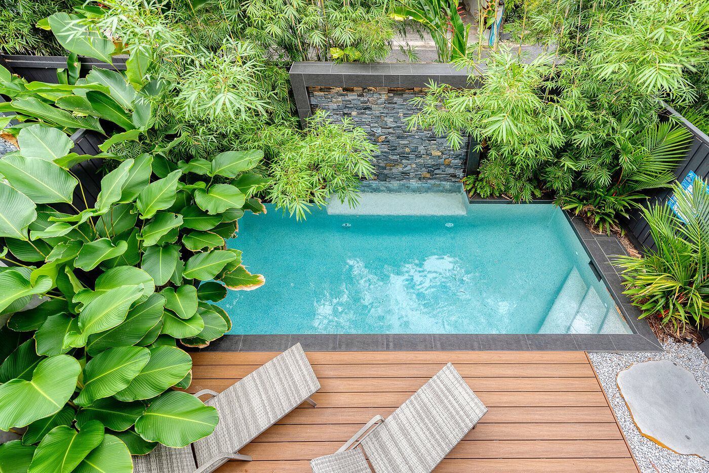 A Large Swimming Pool Surrounded by A Fence and Steps — Pools Plus NQ in Port Douglas, QLD