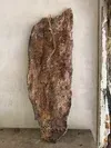 Large brown, textured hanging object against a white wall near a doorway