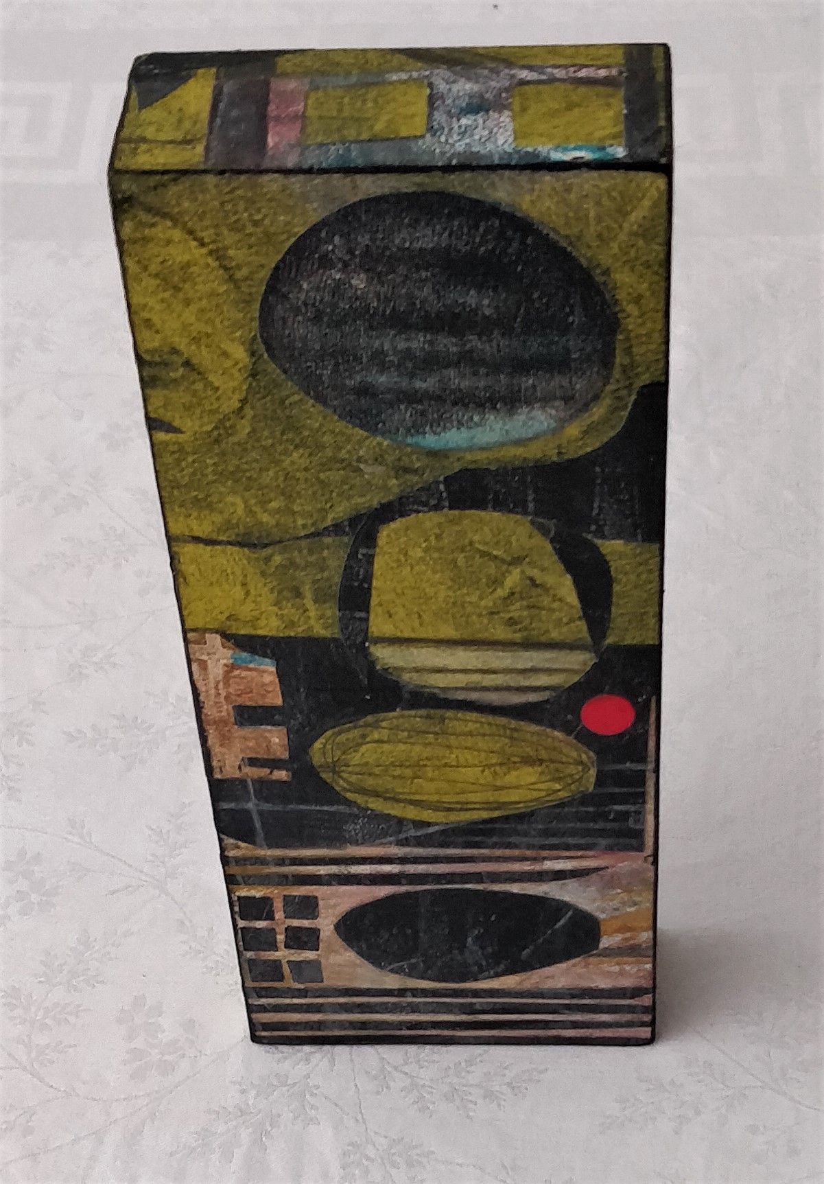 a box with painting on it is sitting on a table .