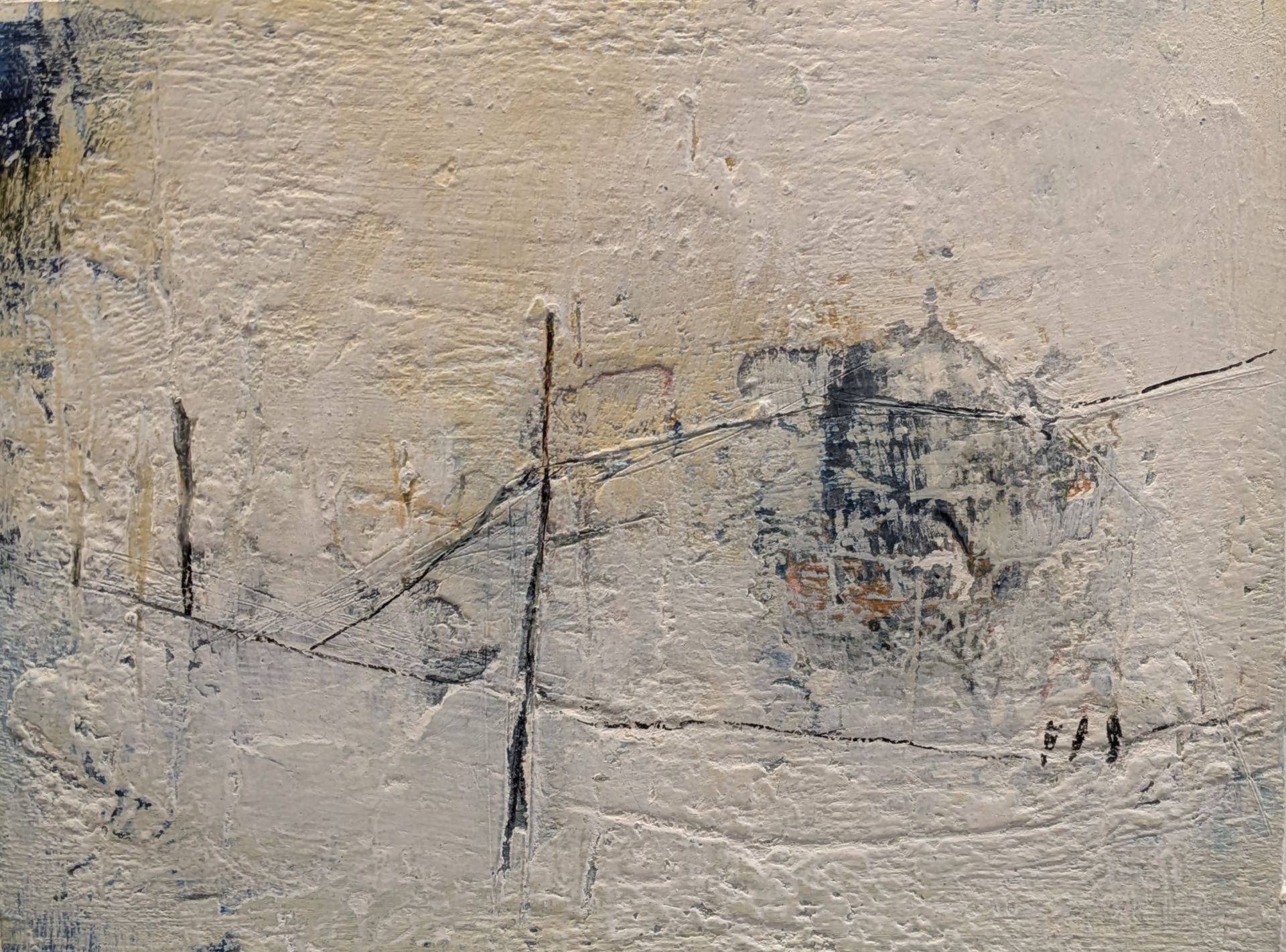 A close up of a painting on a wall with a few people walking in the background.