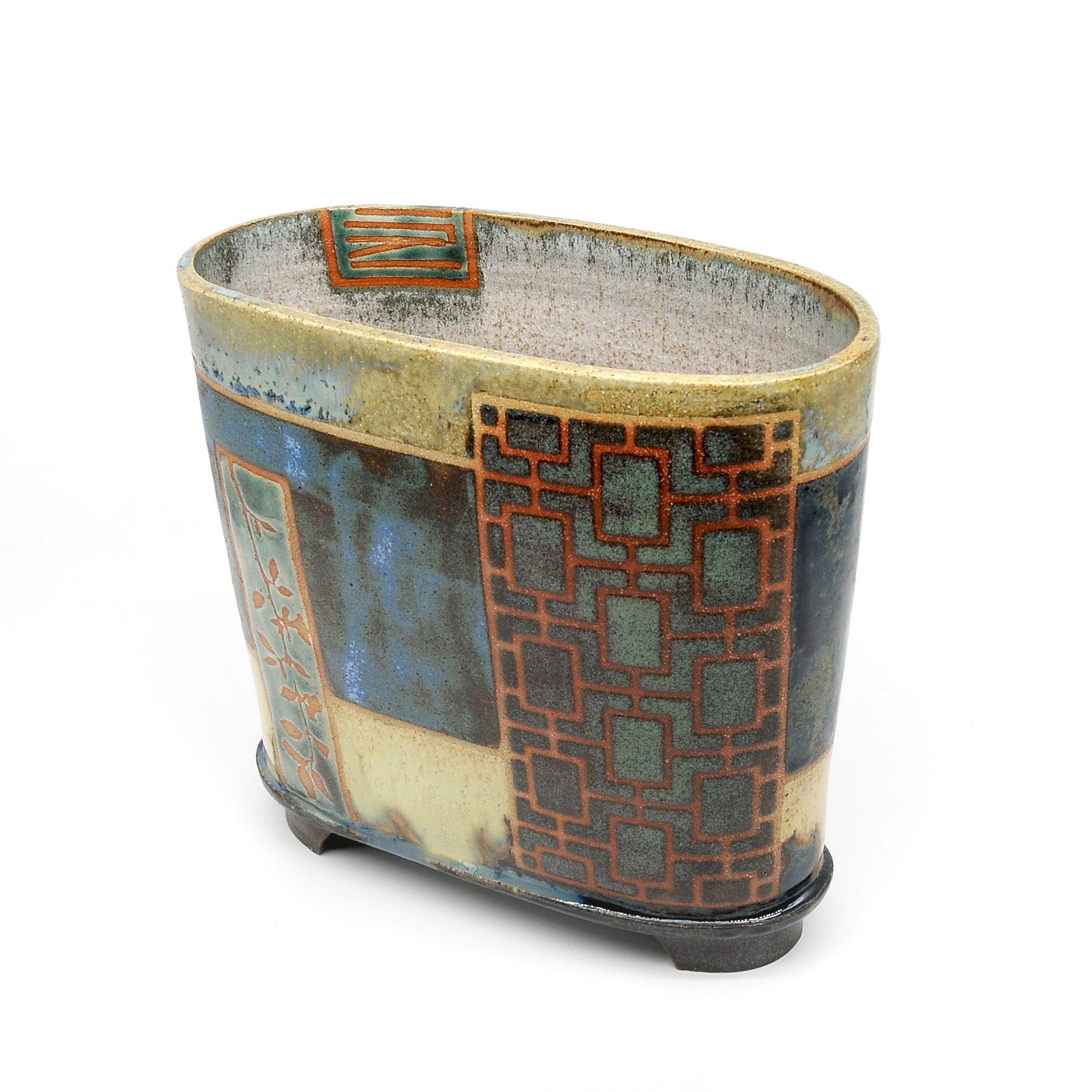 A ceramic vase with a geometric pattern on it