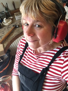 A woman wearing ear muffs and a striped shirt