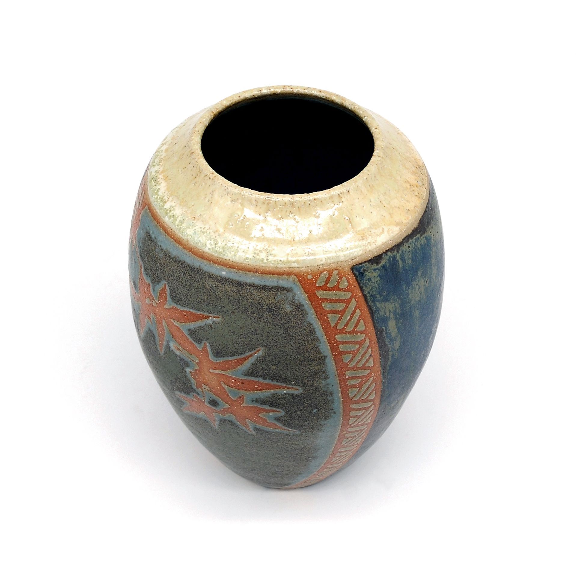 a ceramic vase with a native american design on it