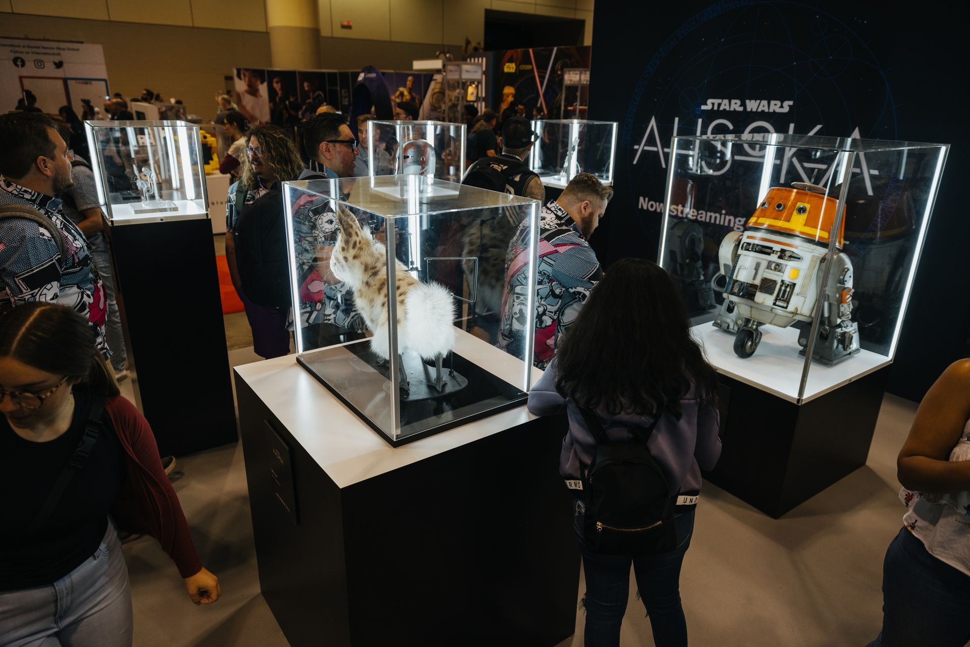 A group of people are looking at a star wars display.