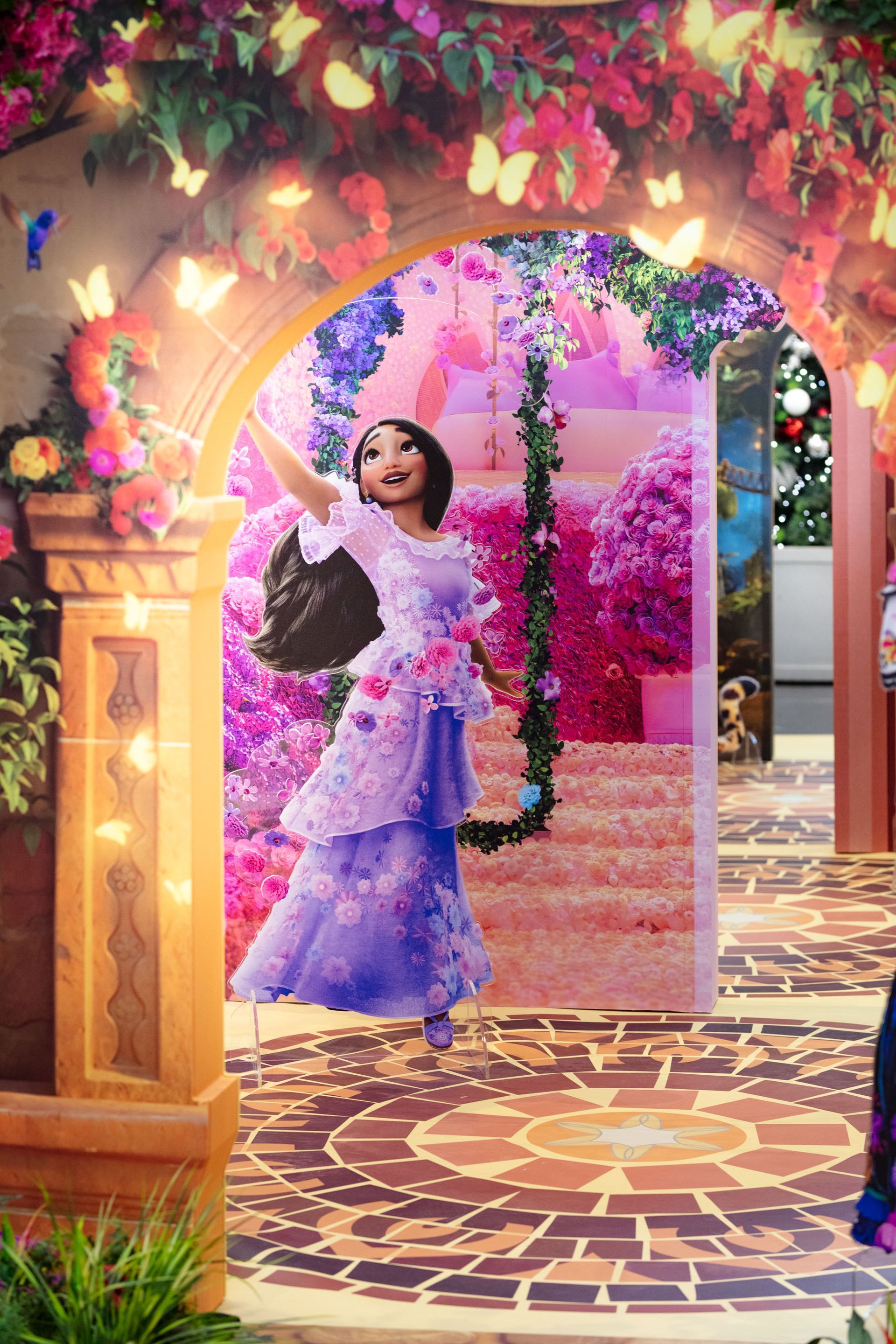 A woman in a purple dress is standing on a swing in a room.