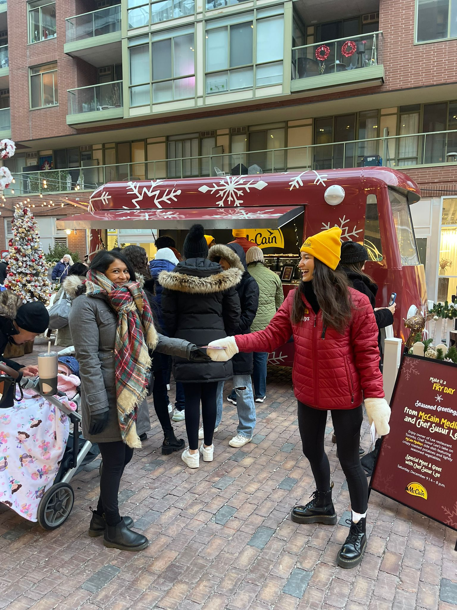 A group of people are standing in front of a food truck.