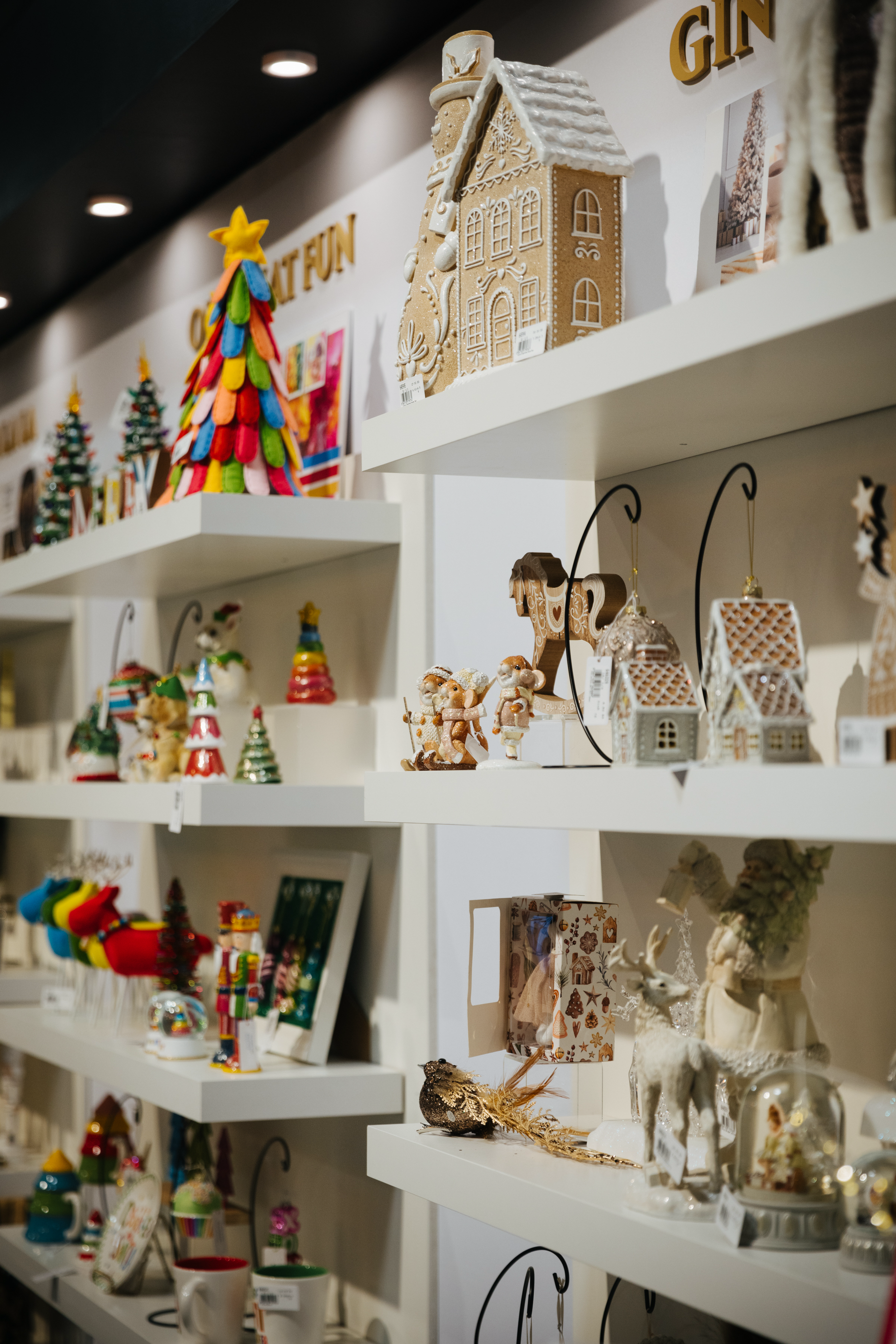 A display of christmas decorations on shelves in a store.