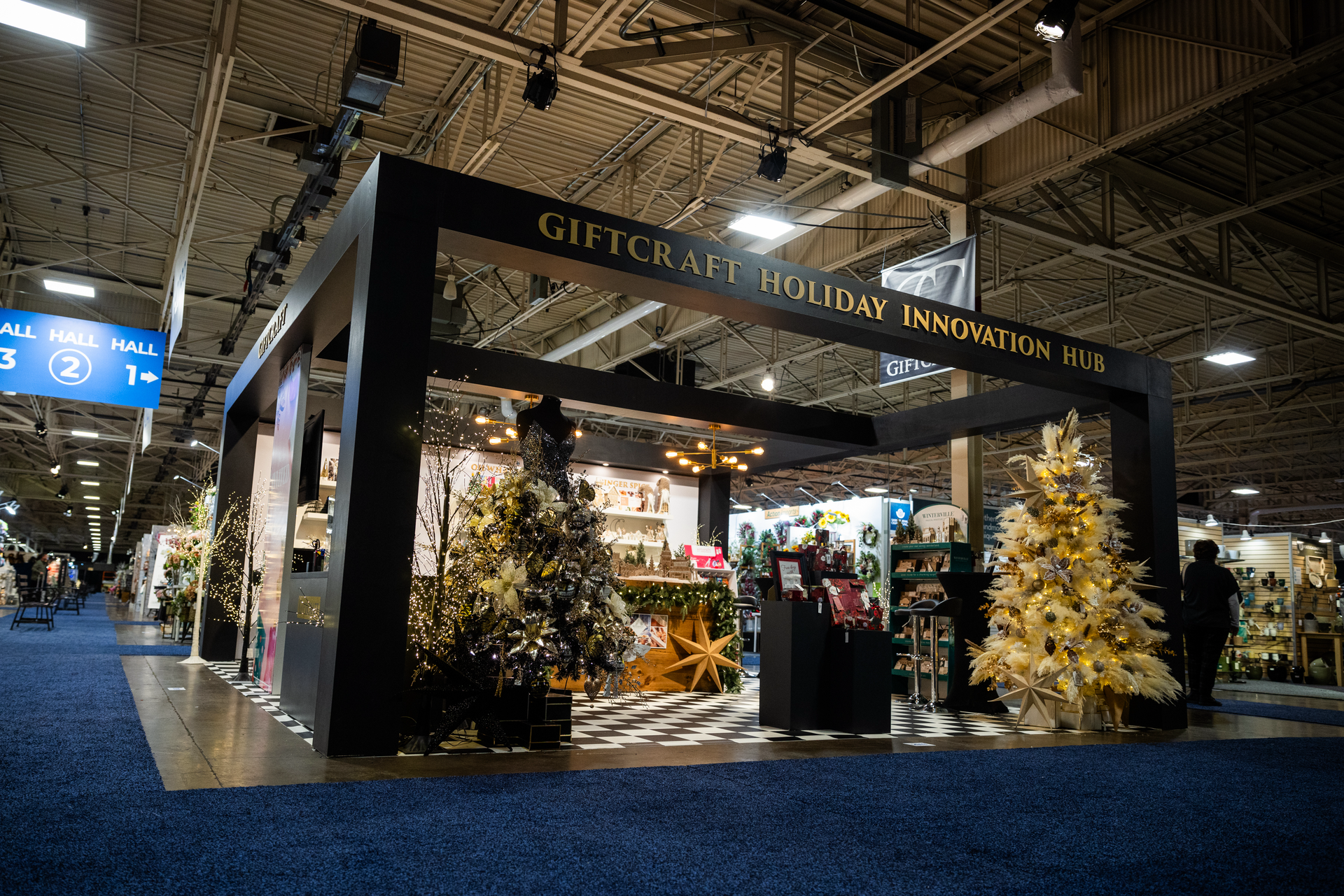 A large building with christmas trees and a sign that says giftcraft holiday innovation