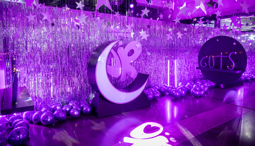 A room filled with purple balloons and a purple moon.