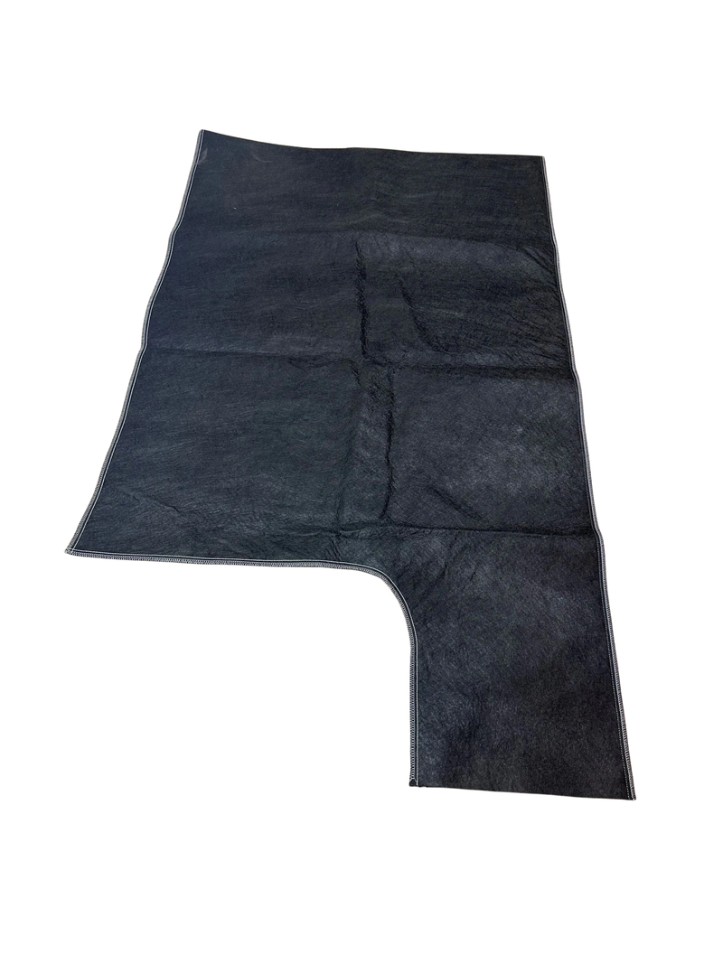 A dark-colored, rectangular mat with a cut-out corner, featuring a textured, carpet-like surface.