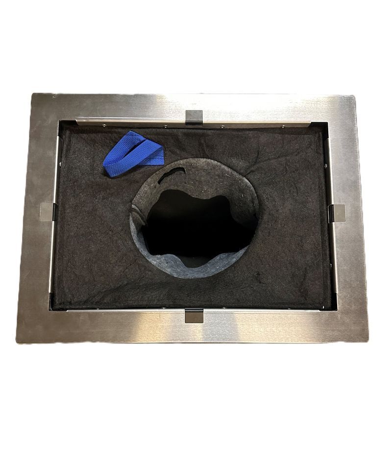 A rectangular metal ceiling register frame containing a black foam filter with a central circular opening and a blue tab.