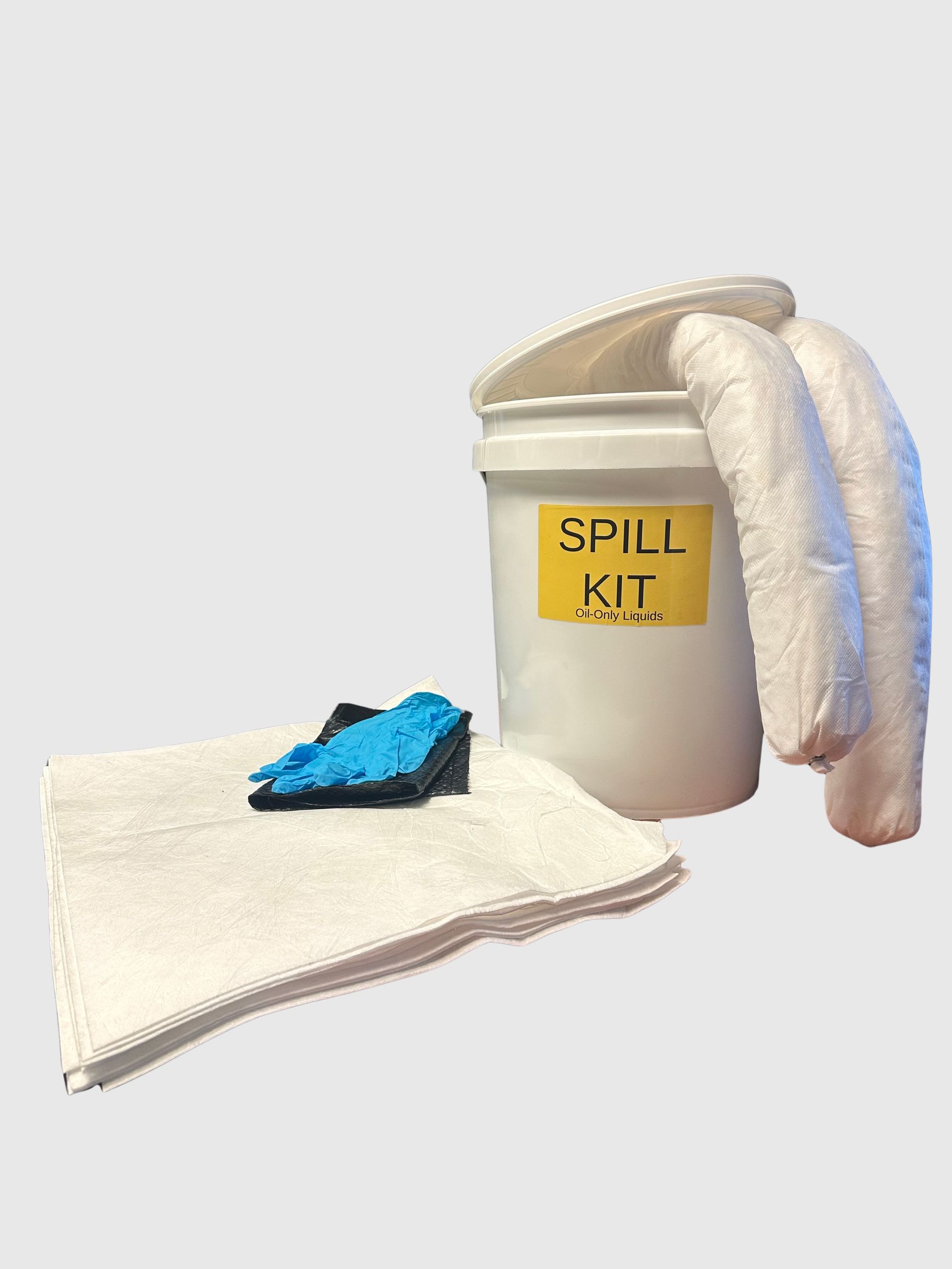 A white spill kit bucket with a yellow label, two absorbent socks draped over it, a white pad, and blue gloves.