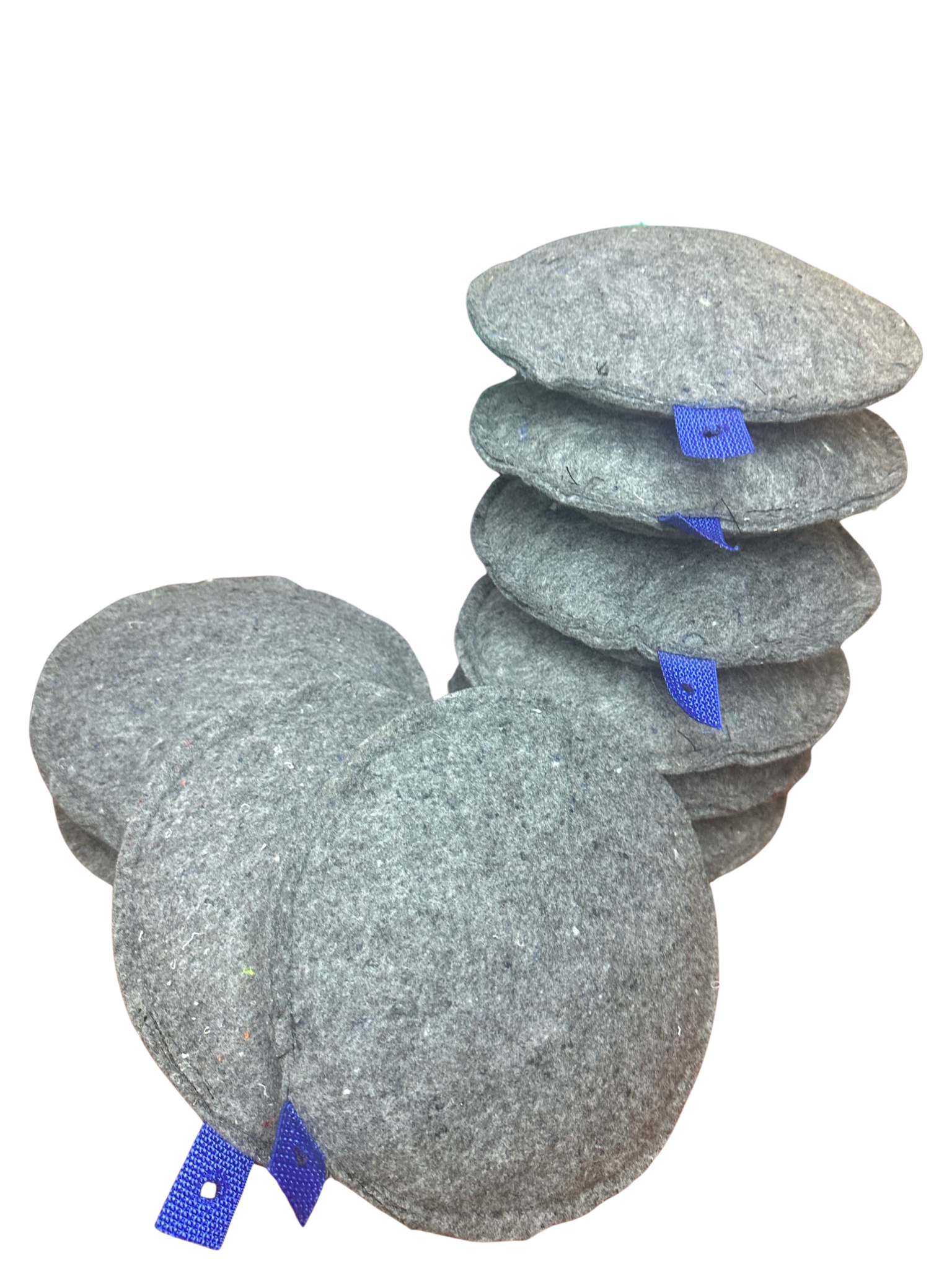 A stack of round, textured gray sponges with small blue hanging loops attached to the side.