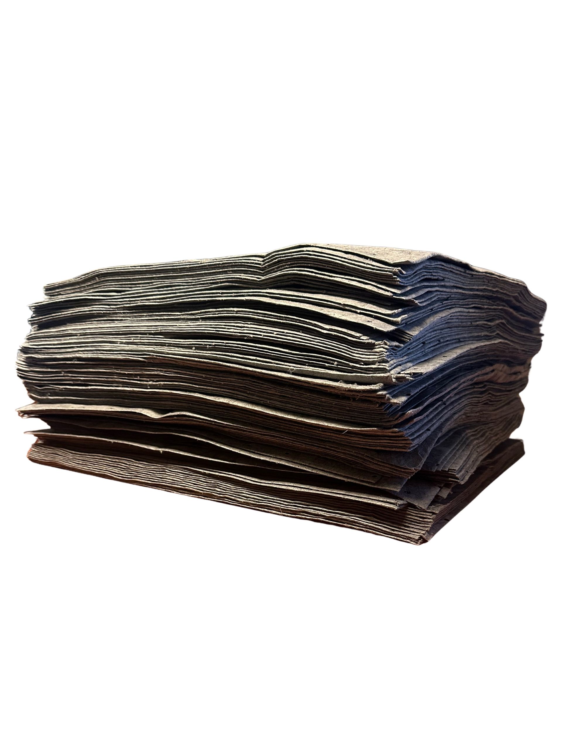 A thick, rectangular stack of dark, textured corrugated cardboard sheets isolated on a white background.
