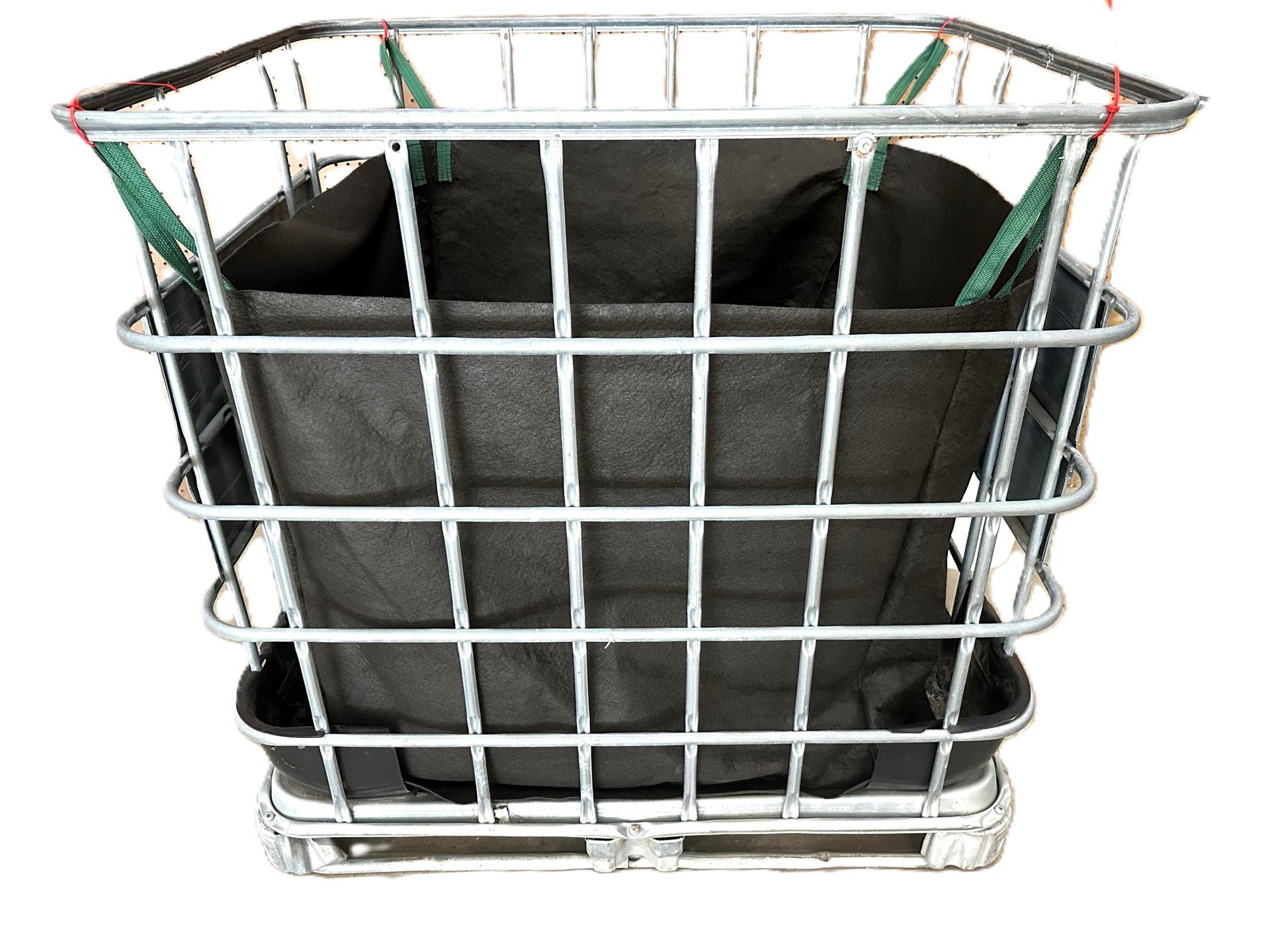 White wire basket holding a folded black fabric bag