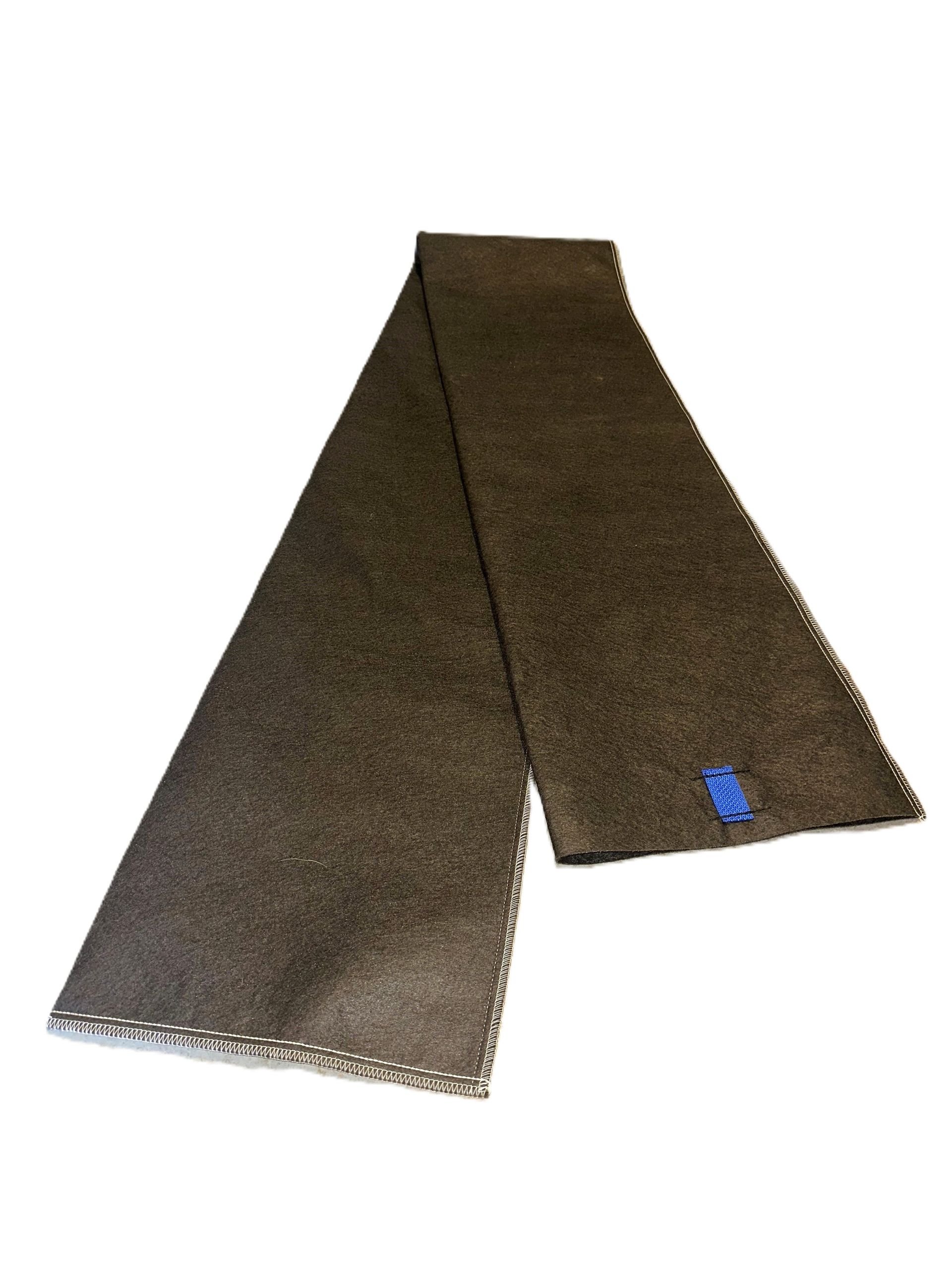 Folded brown textured mat with a small blue label on top