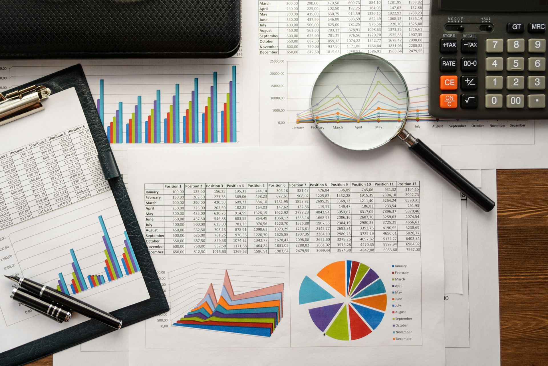 Business Auditing — Perth, WA — Owen & Plaistowe A calculator, financial documents, and a pen arranged on a desk, symbolising accounting tasks