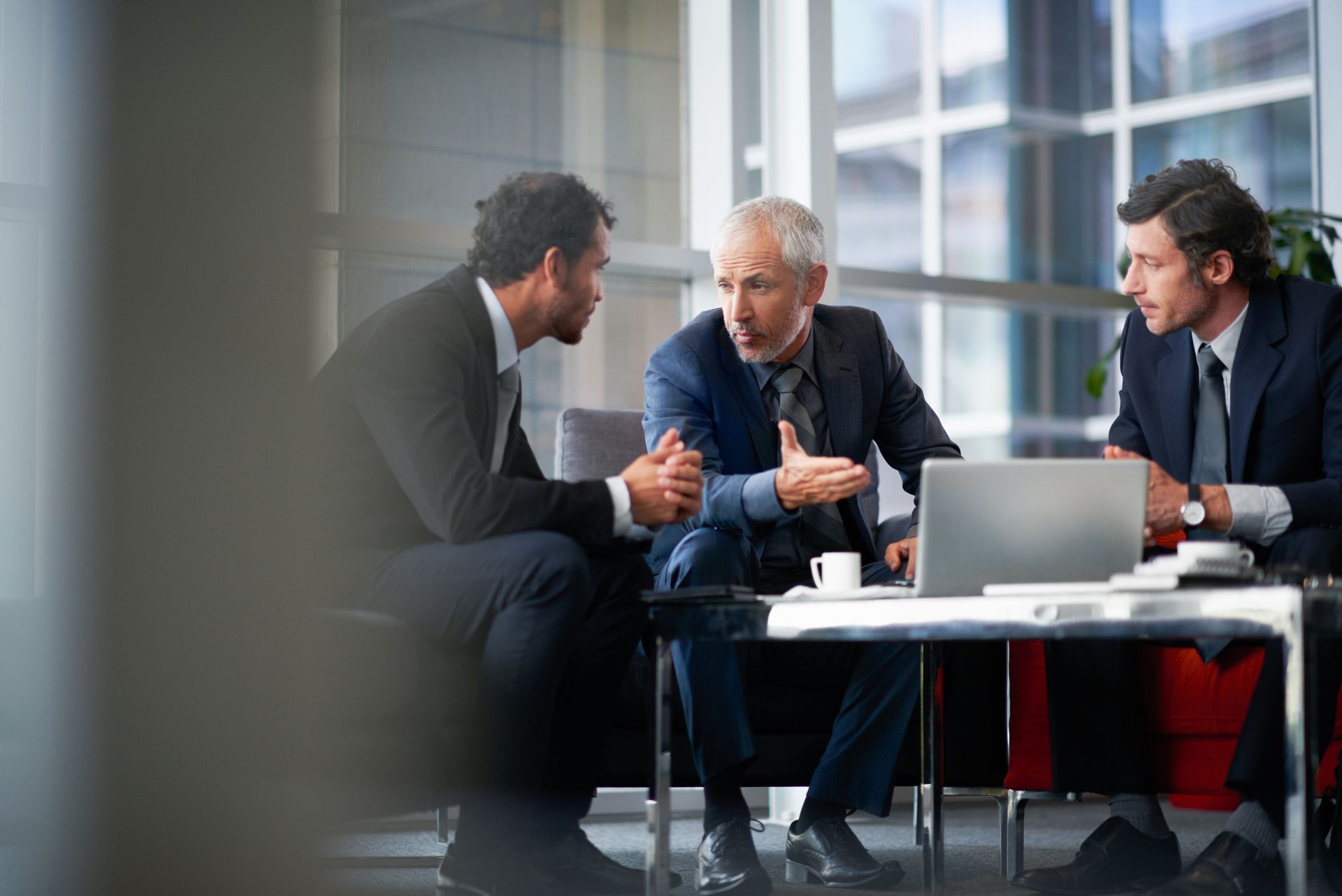 Two business advisors and their client are having a corporate meeting. Two business advisors and their client are having a corporate meeting.