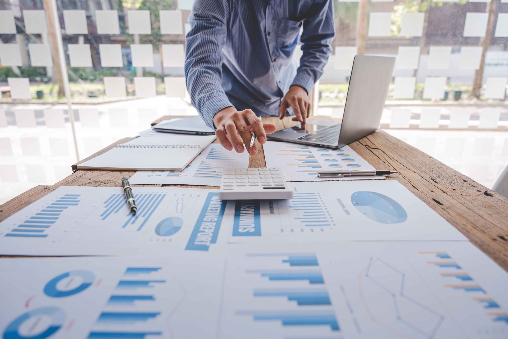 A businessman calculating the taxes of a business. A businessman calculating the taxes of a business.